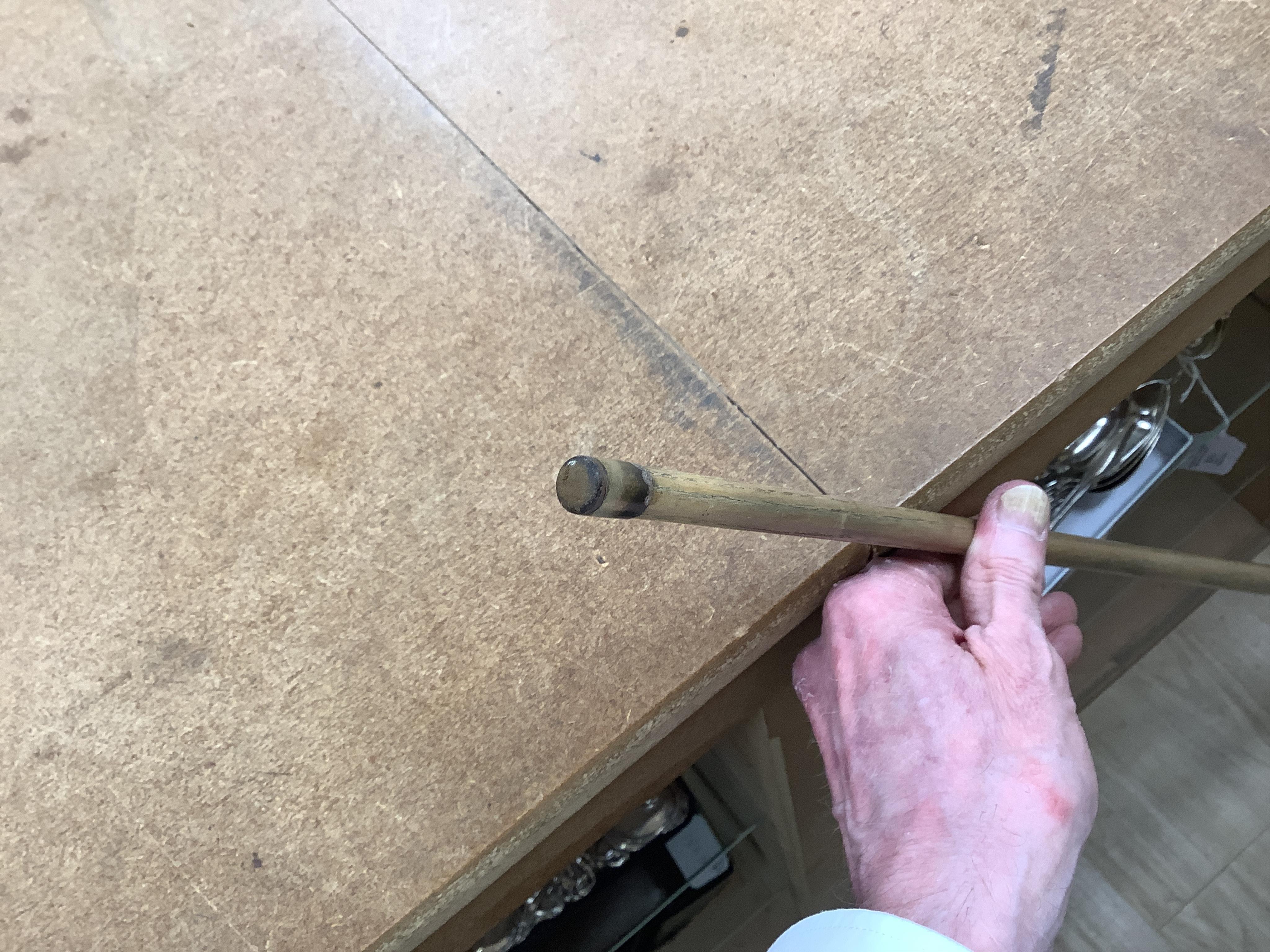 A collection of tribal spears, a fish hook, a cased snooker cue, etc.